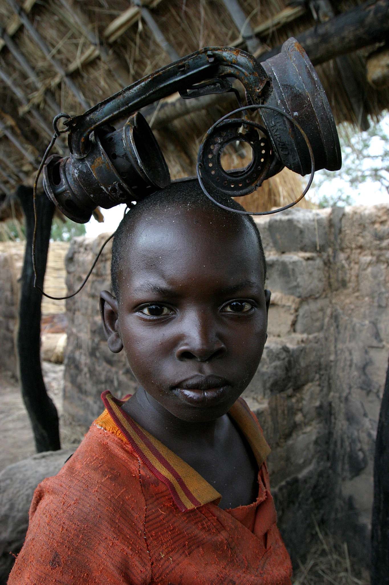 A boy playing with a burnt lamp — in the city of Birao, Central…