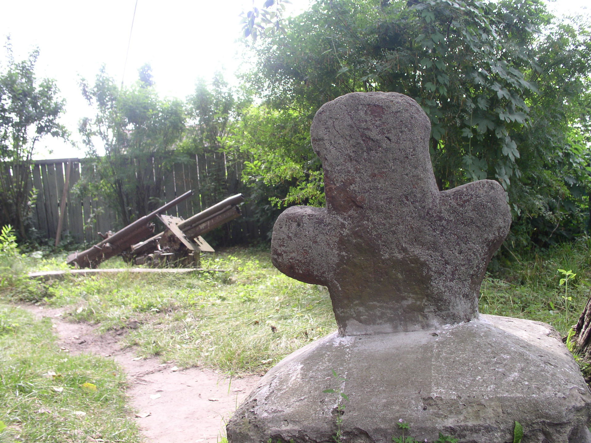 Pre-Christian stone idol and WW2 time artillery pieces in the y…