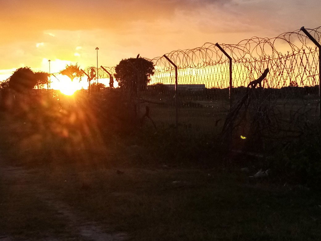 Sunset as see through Namibia and Angolan border fence, Oshikan…