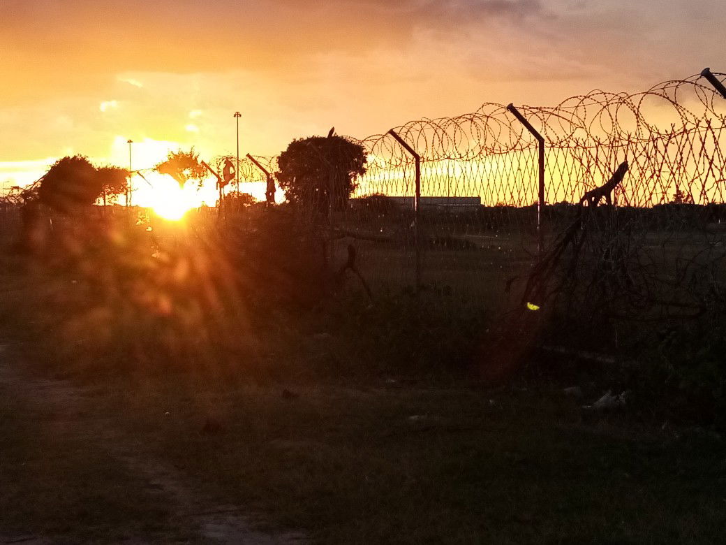 Sunset as see through Namibia and Angolan border fence, Oshikan…