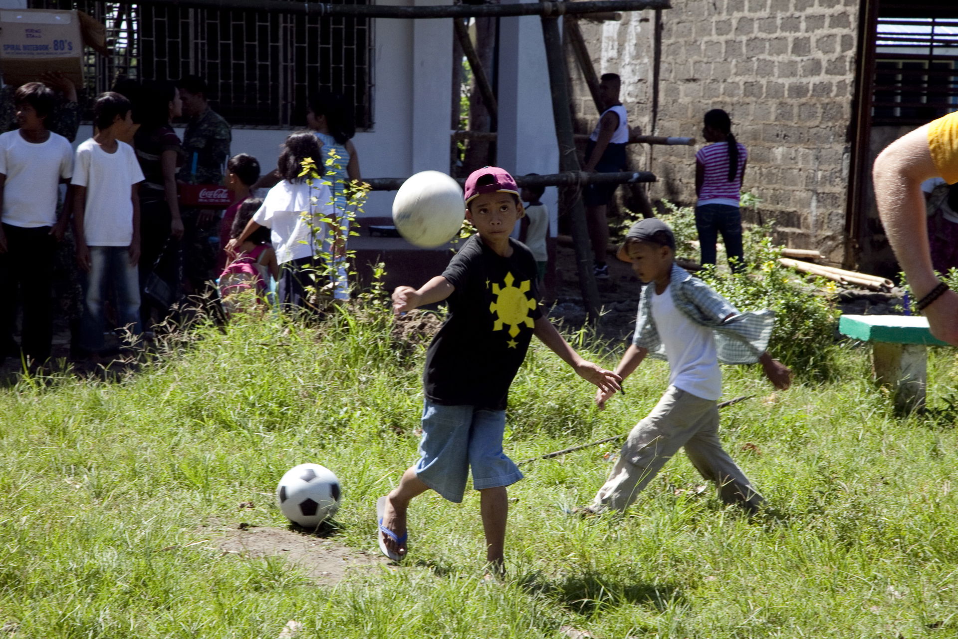 A boy at AboAbo Elementary School plays volleyball with U.S. Na…
