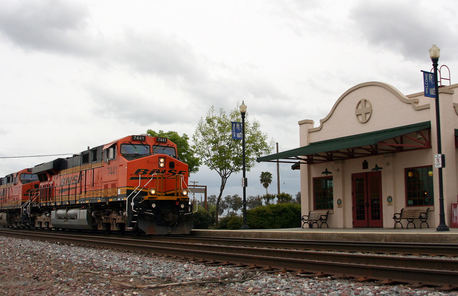 NB intermodal train passing the Amtrak station, Corcoran, Calif…