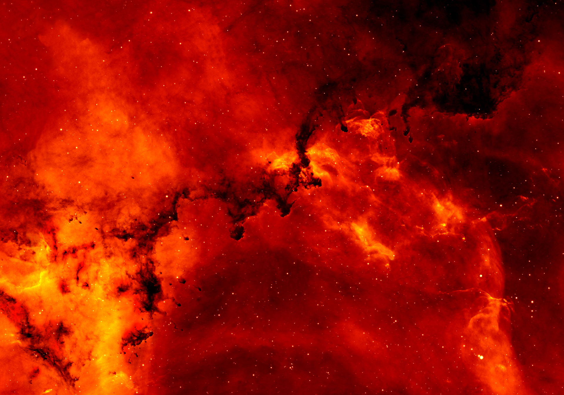 A close up view of the Rosette Nebula. The red color comes from…