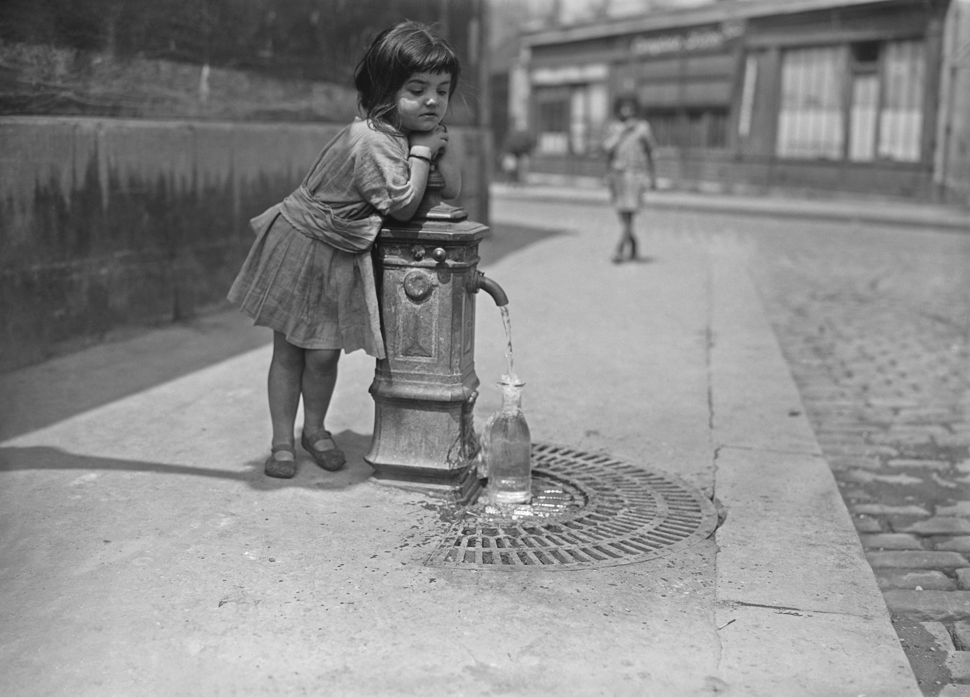 A little girl and a standpipe, Paris, France.