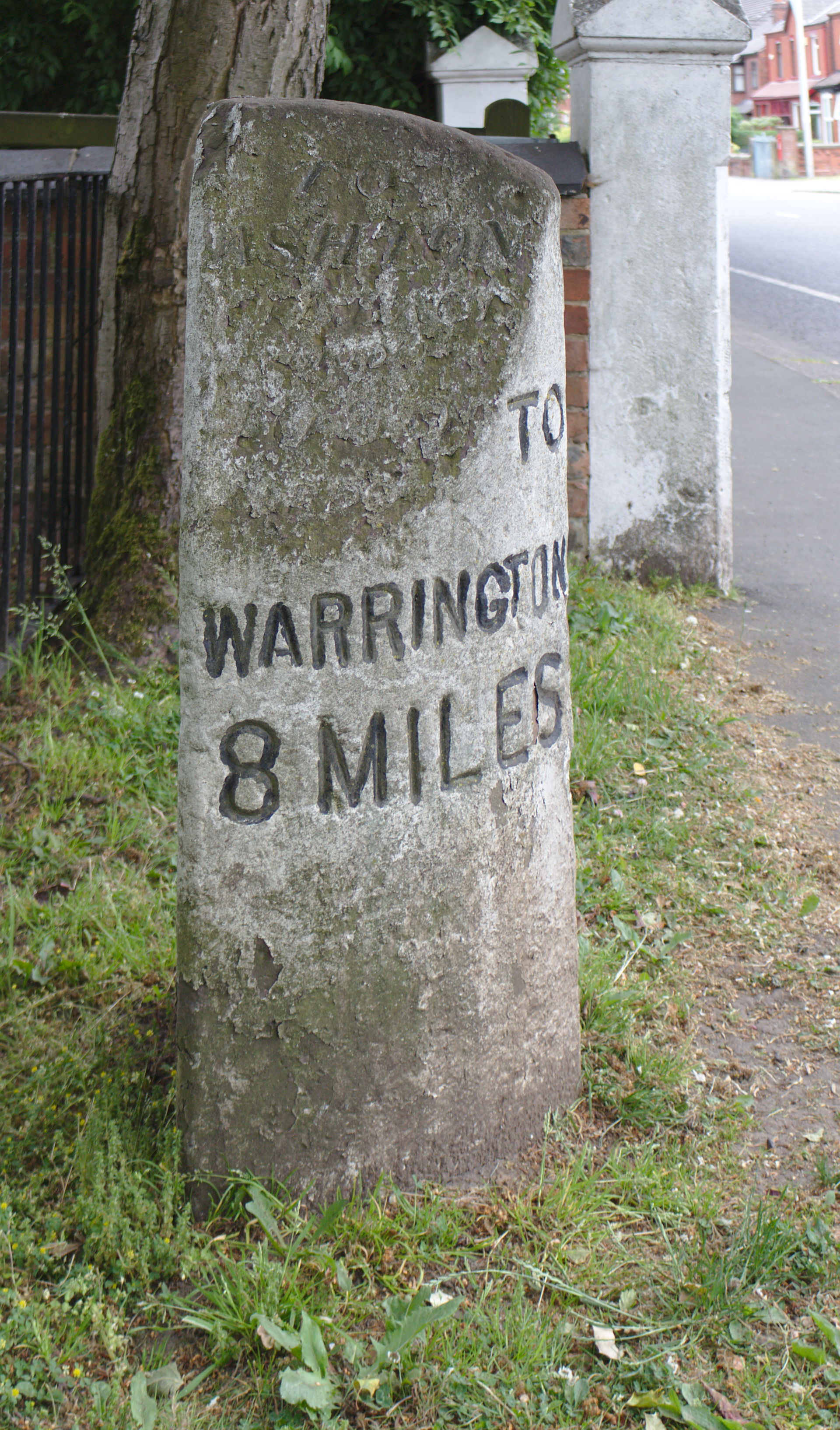 North side, showing 8 miles to Warrington.