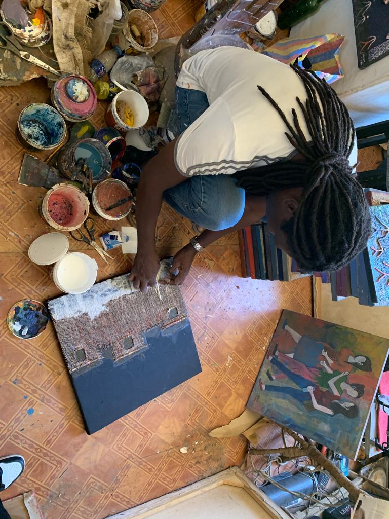 The artist uses ebony, jute bag and canvas to draw on the paint…