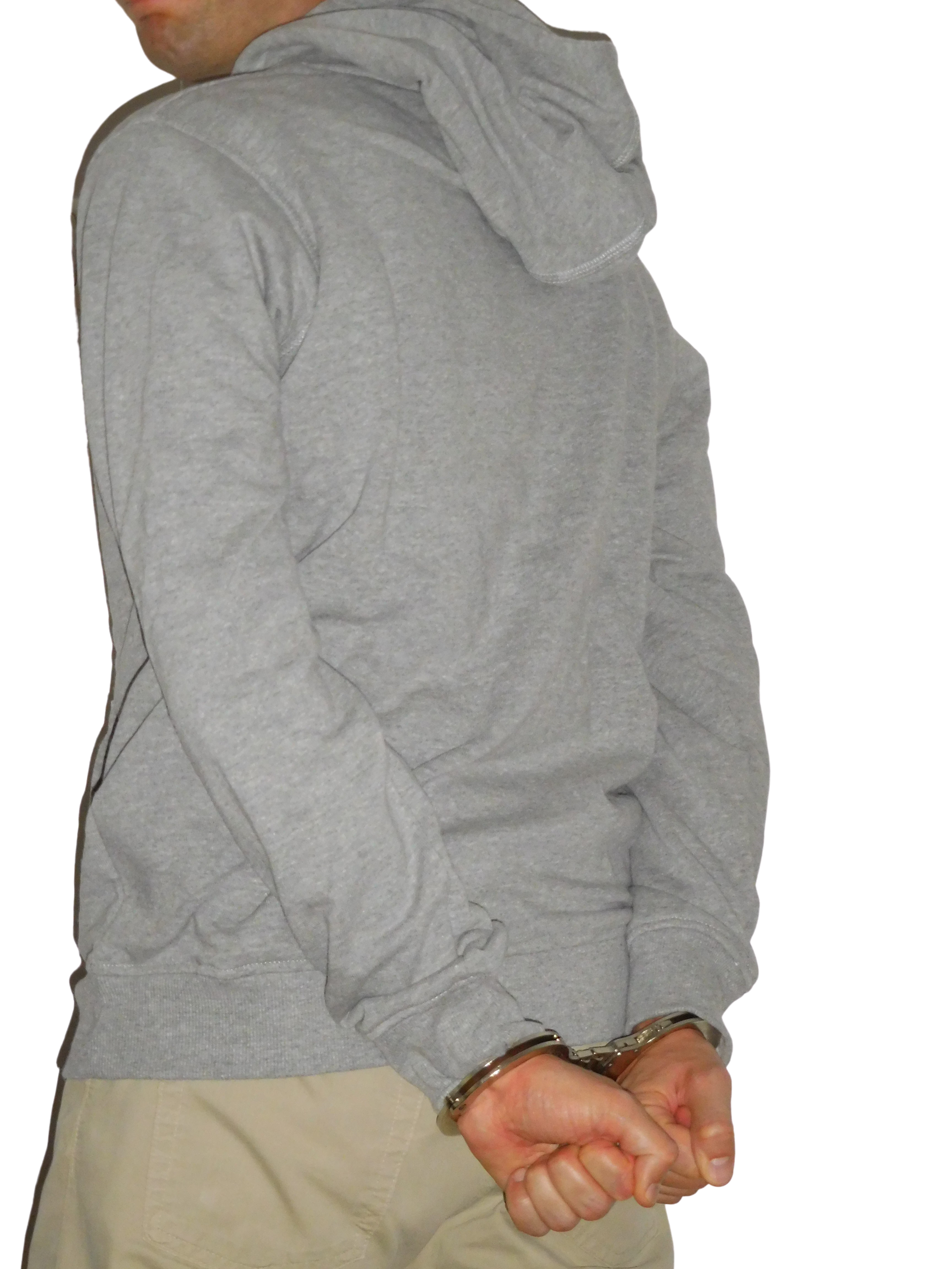 Arrested male standing with the hands cuffed behind the back