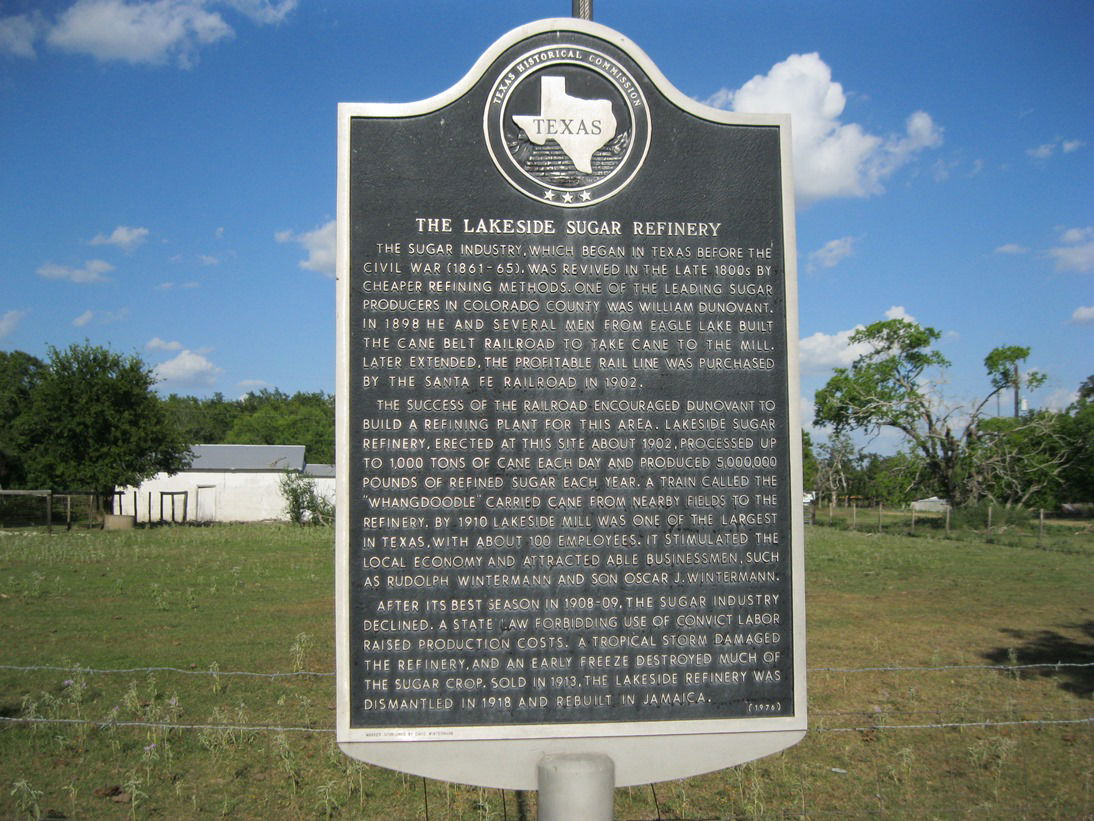 Photo shows an historical marker at the site of a one-time suga…