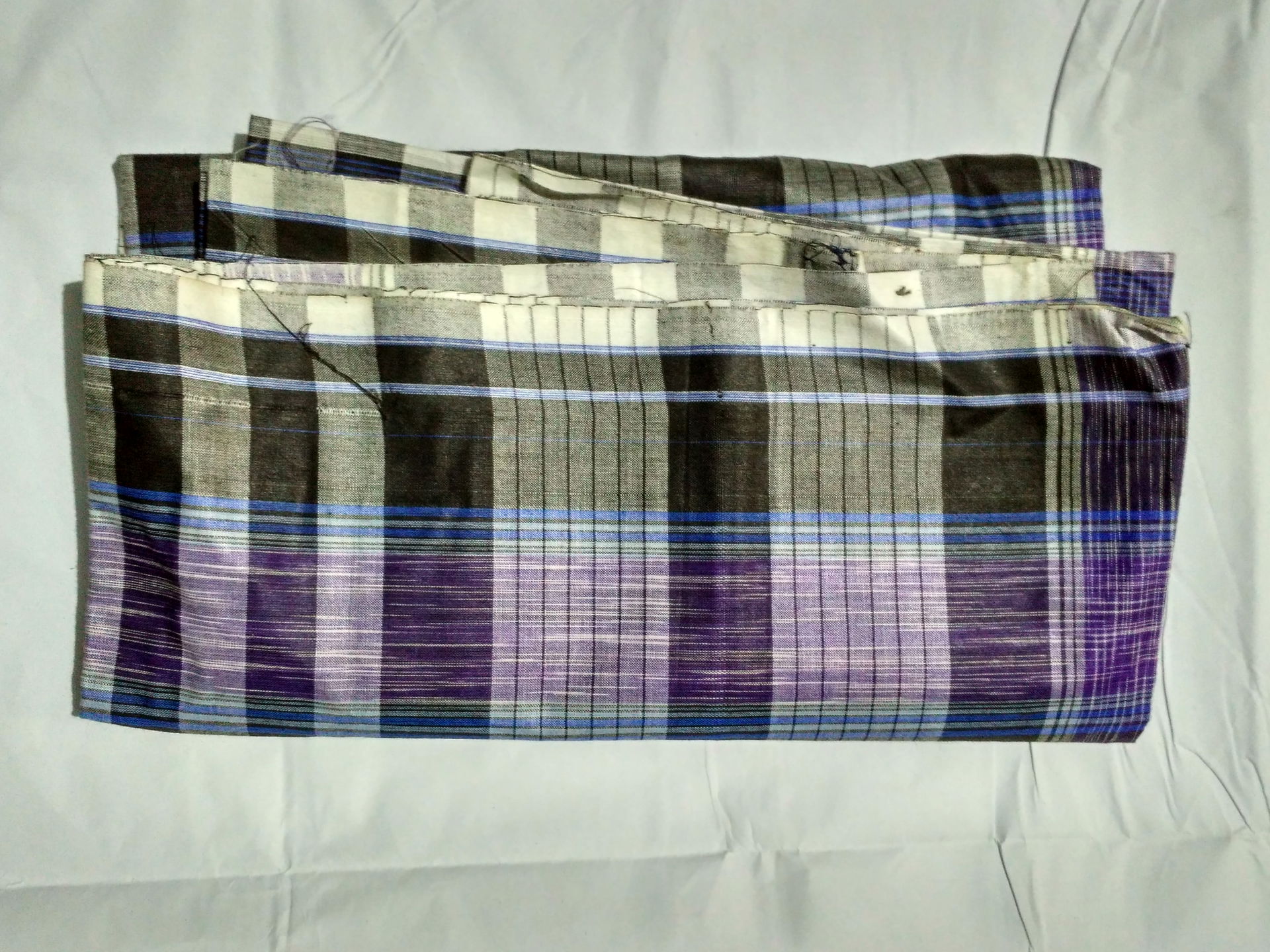 Photo of a folded Lungi of Bangladesh. The design of the boarde…