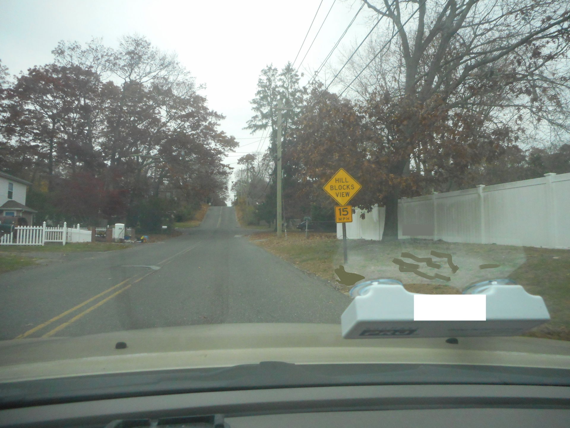 "Hill Blocks View" warning sign with a supplemental speed advis…