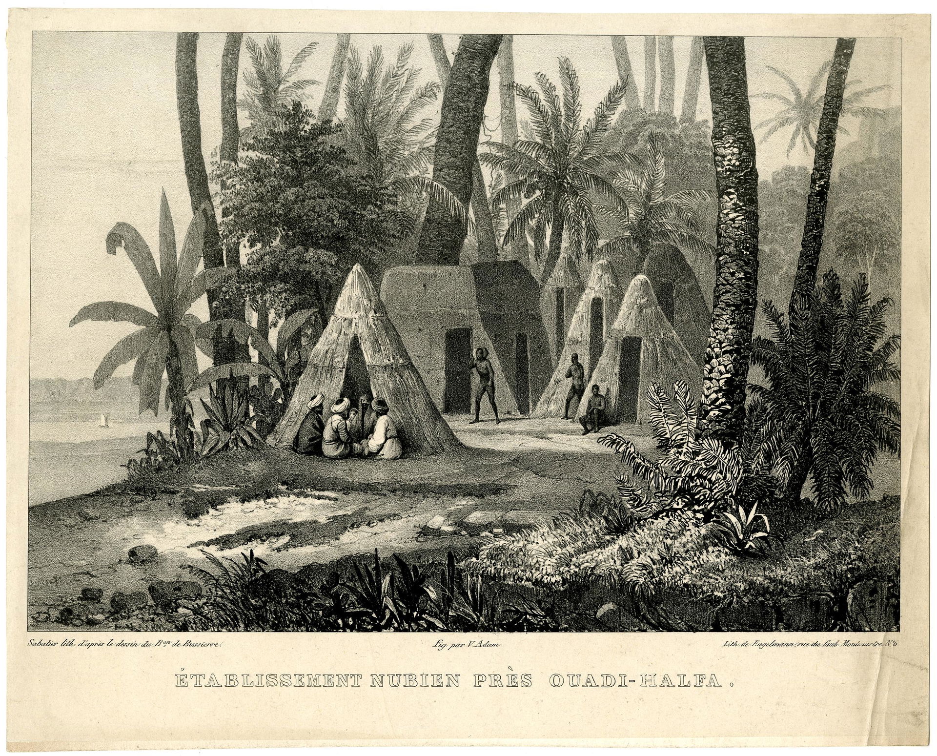 View of a village with huts between palm trees and other trees,…