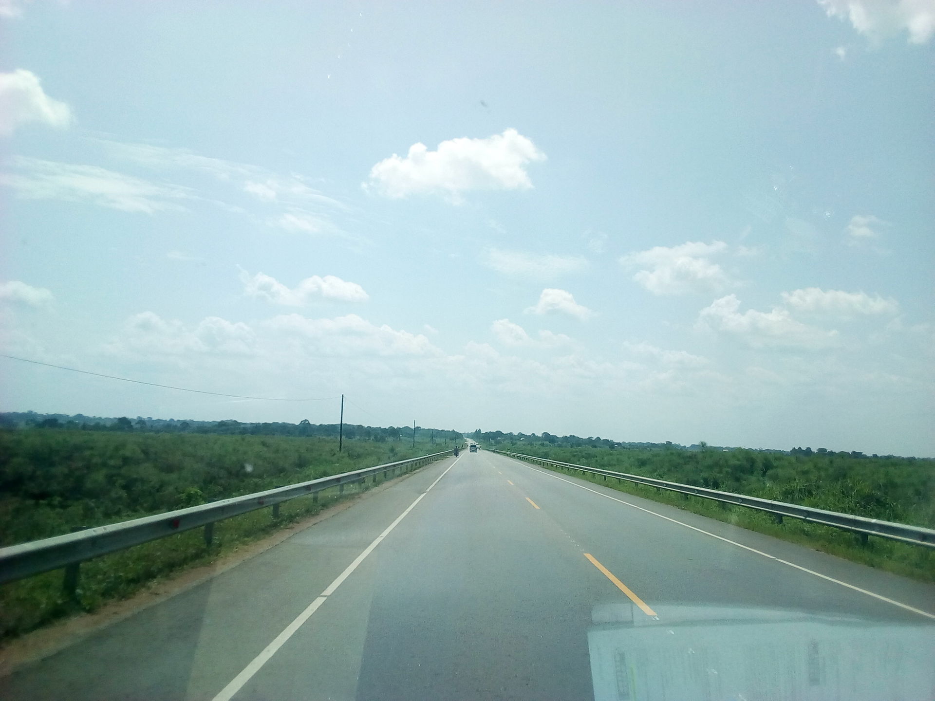 Tirinyi Mbale Highway with blue Sky covered in spotted clouds i…