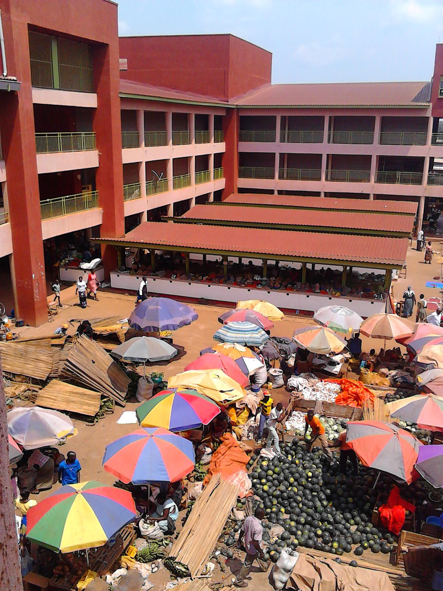 Sales going on at Hoima Market Uganda. Umbrellas and papyrus ma…
