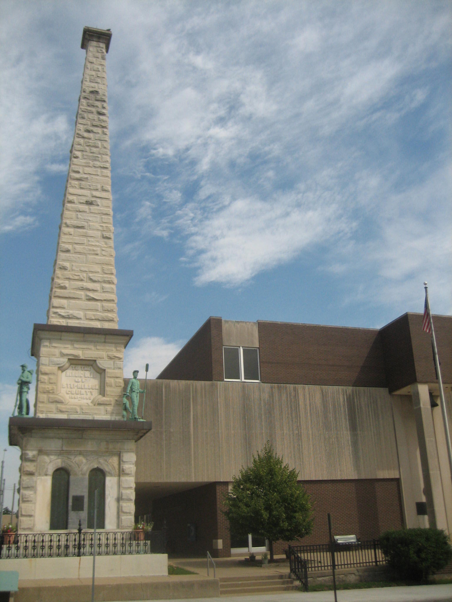 Soldiers' Monument, flanked by the Stephenson County Courthouse…