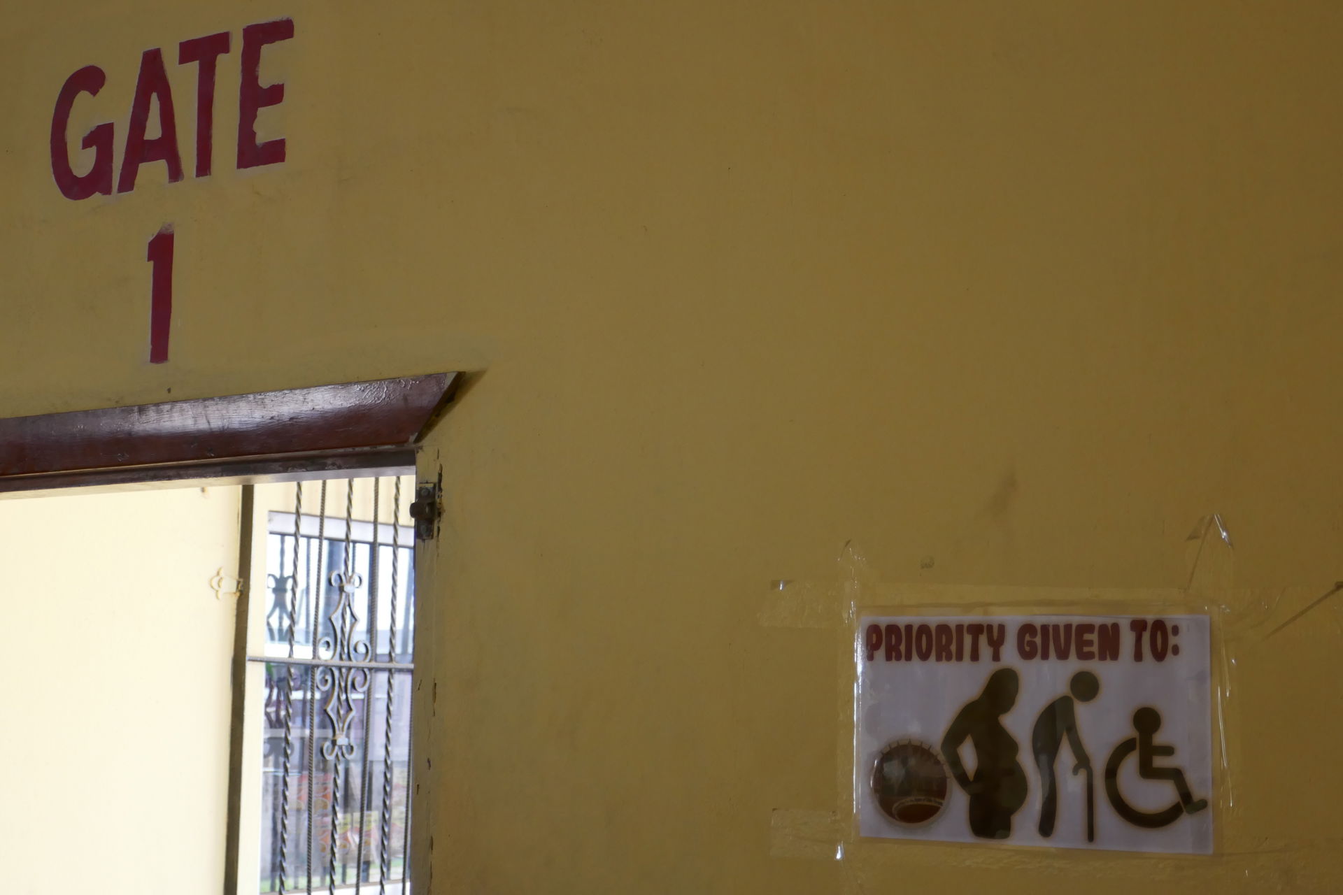 12/9, Big camera--Sign in the Dangriga bus station--"Give prior…