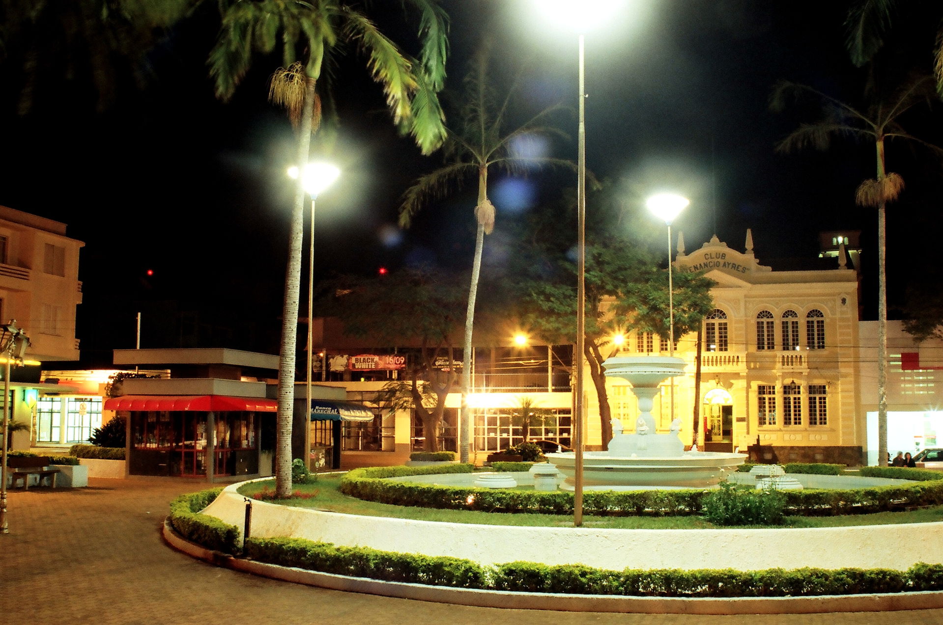 Largo dos Amores square at night, with club Venâncio Ayres on t…