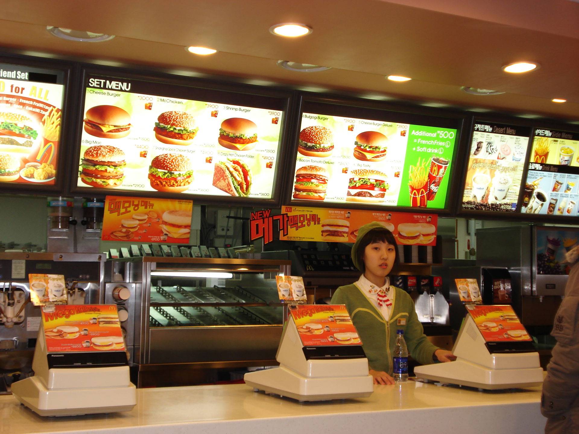 A not so happy Korean worker. The cash register and menu at the…