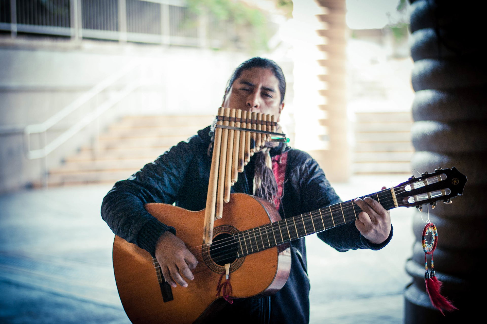 Street performer plays guitar and pan flute in Castro Valley, C…