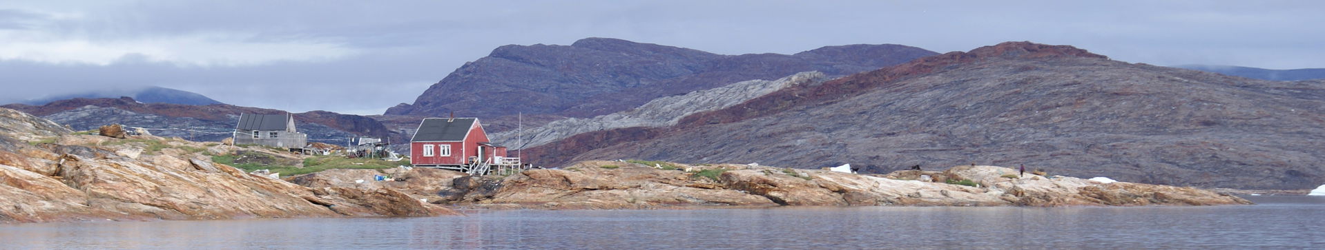 Former settlement of Ikerasaarsuk, and Qallunaat Island behind,…