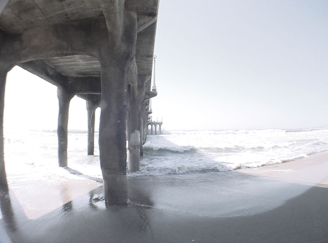 UNDER THE MANHATTAN BEACH, CA PIER ON A SUNNY CALIFORNIA WINTER…