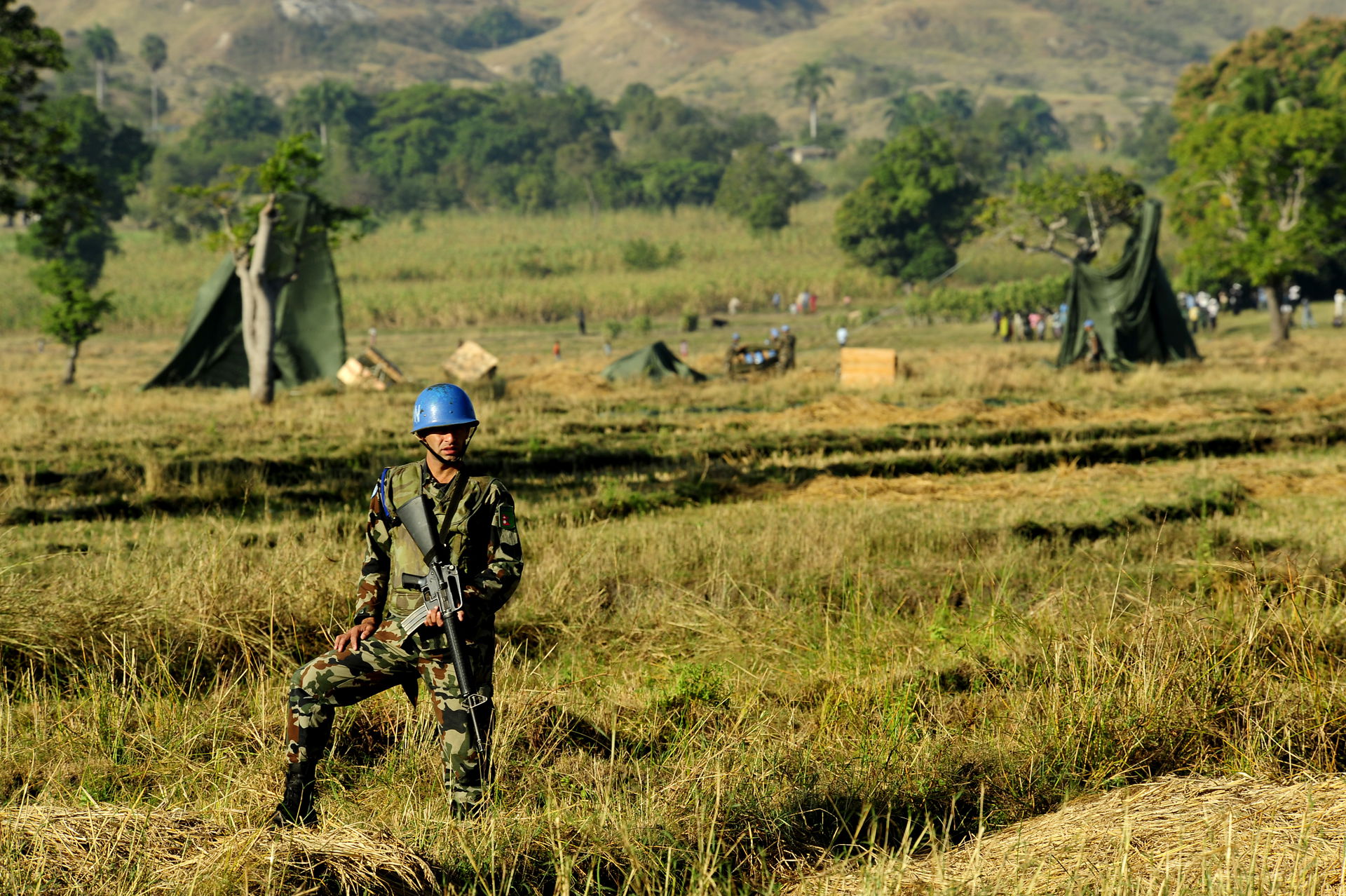 A Nepalese soldier provides security after a U.S. Air Force C-1…