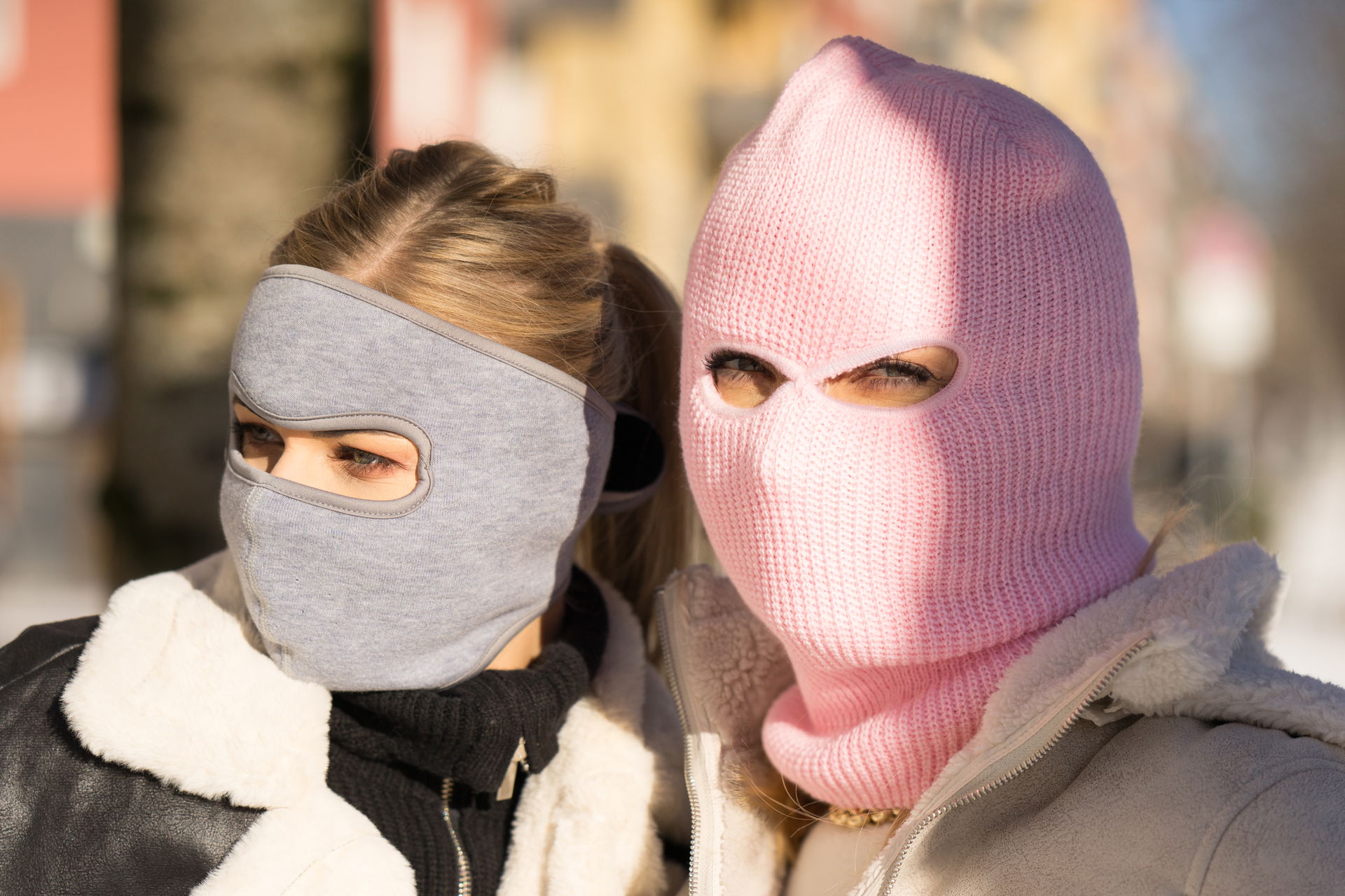 Two women wearing different variants of ski masks. Image idea r…