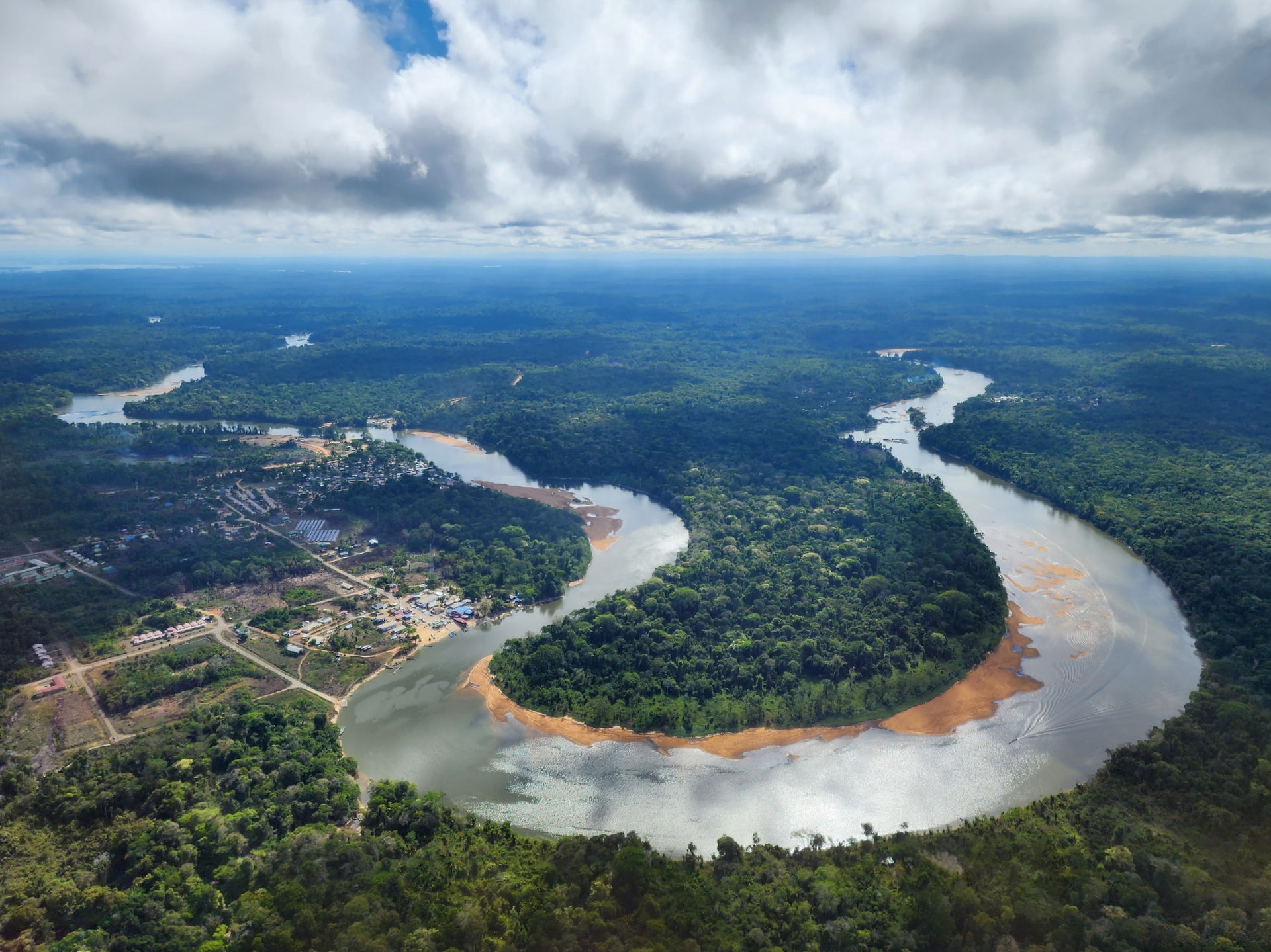 Foto van de Surinamerivier met de volgende dorpen zichtbaar, aa…