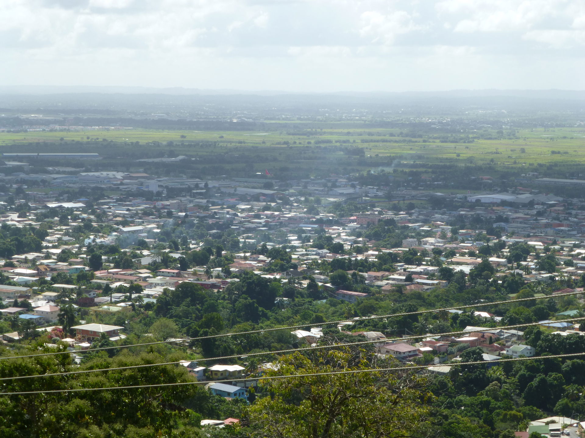 View over Tunapuna (front) and Macoya from Mount St. Benedict. …