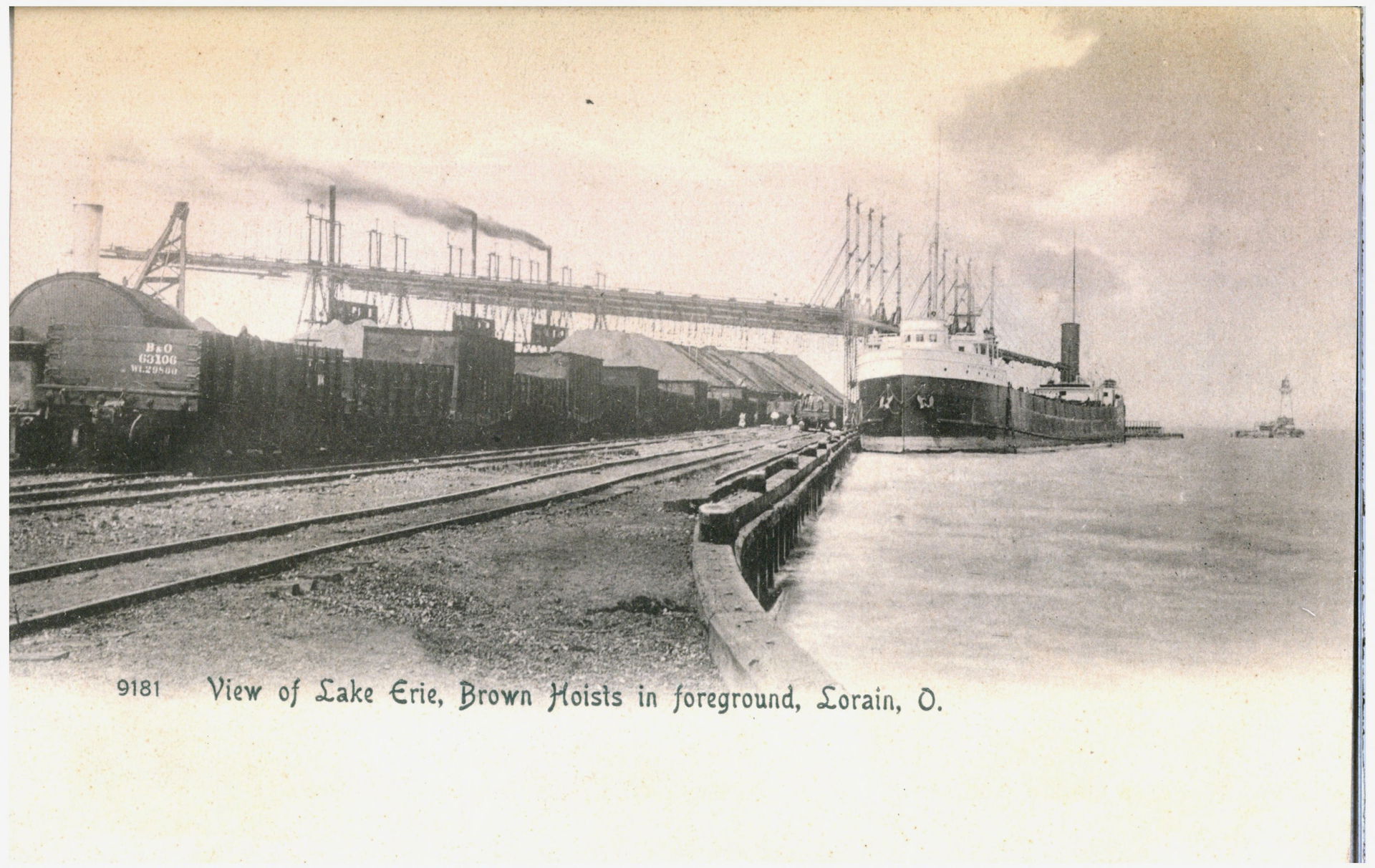 Black and white postcard showing ships on Lake Erie being unloa…