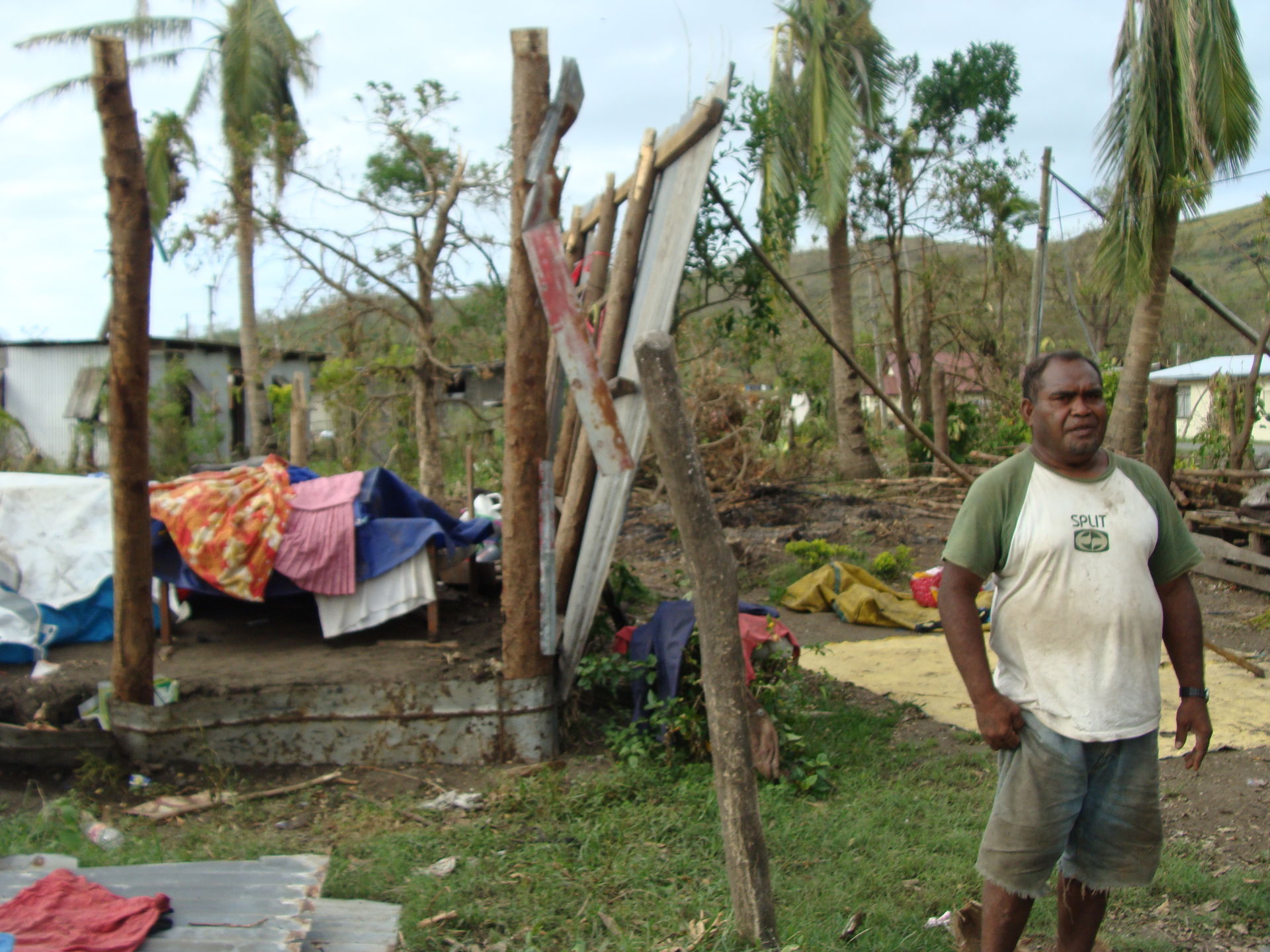 Jovilisi stands outside a destroyed home in Korovou Village, Fi…