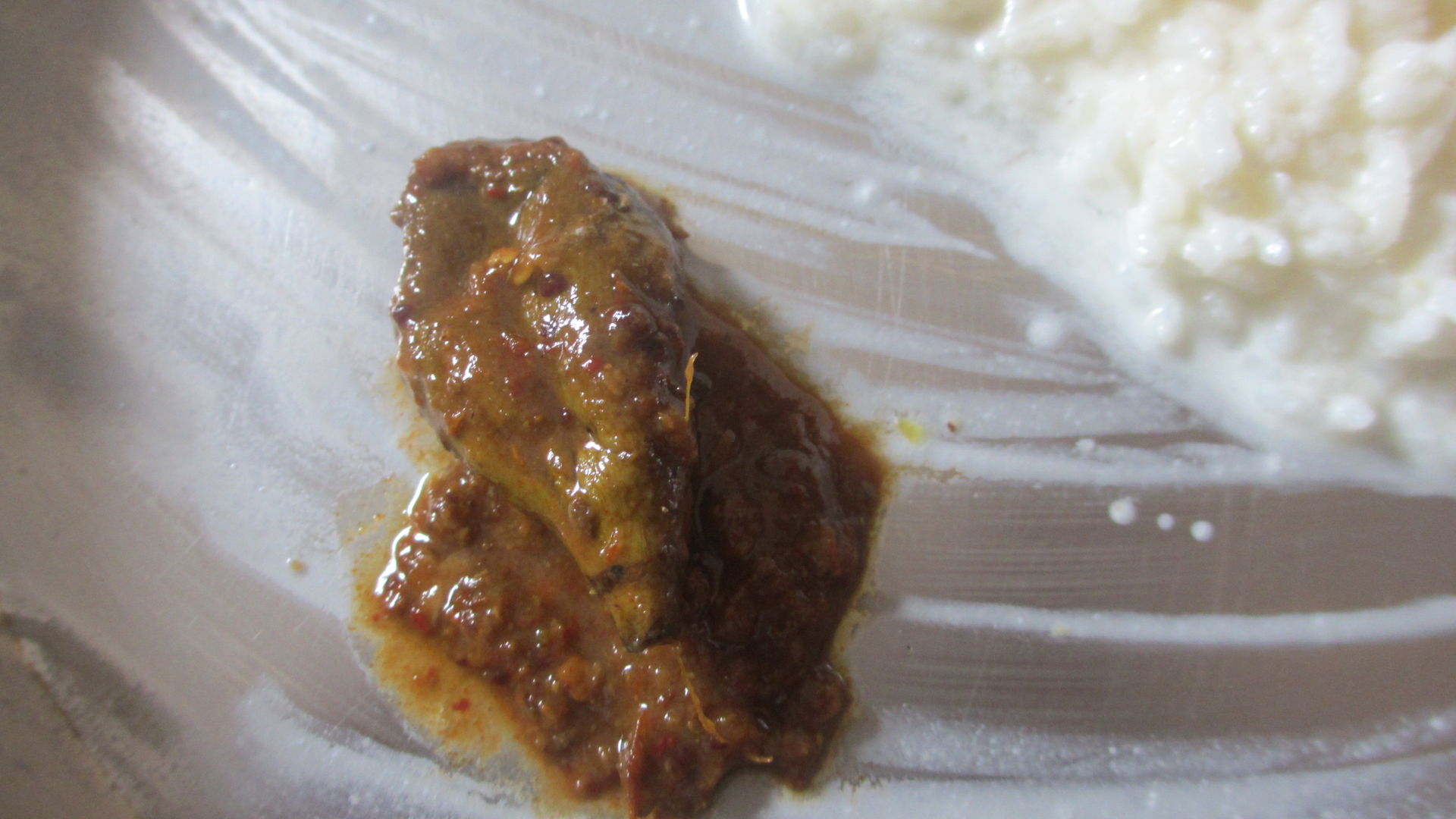 Seasoned Vadu Mangai pickle in a lunch plate with Curd Rice