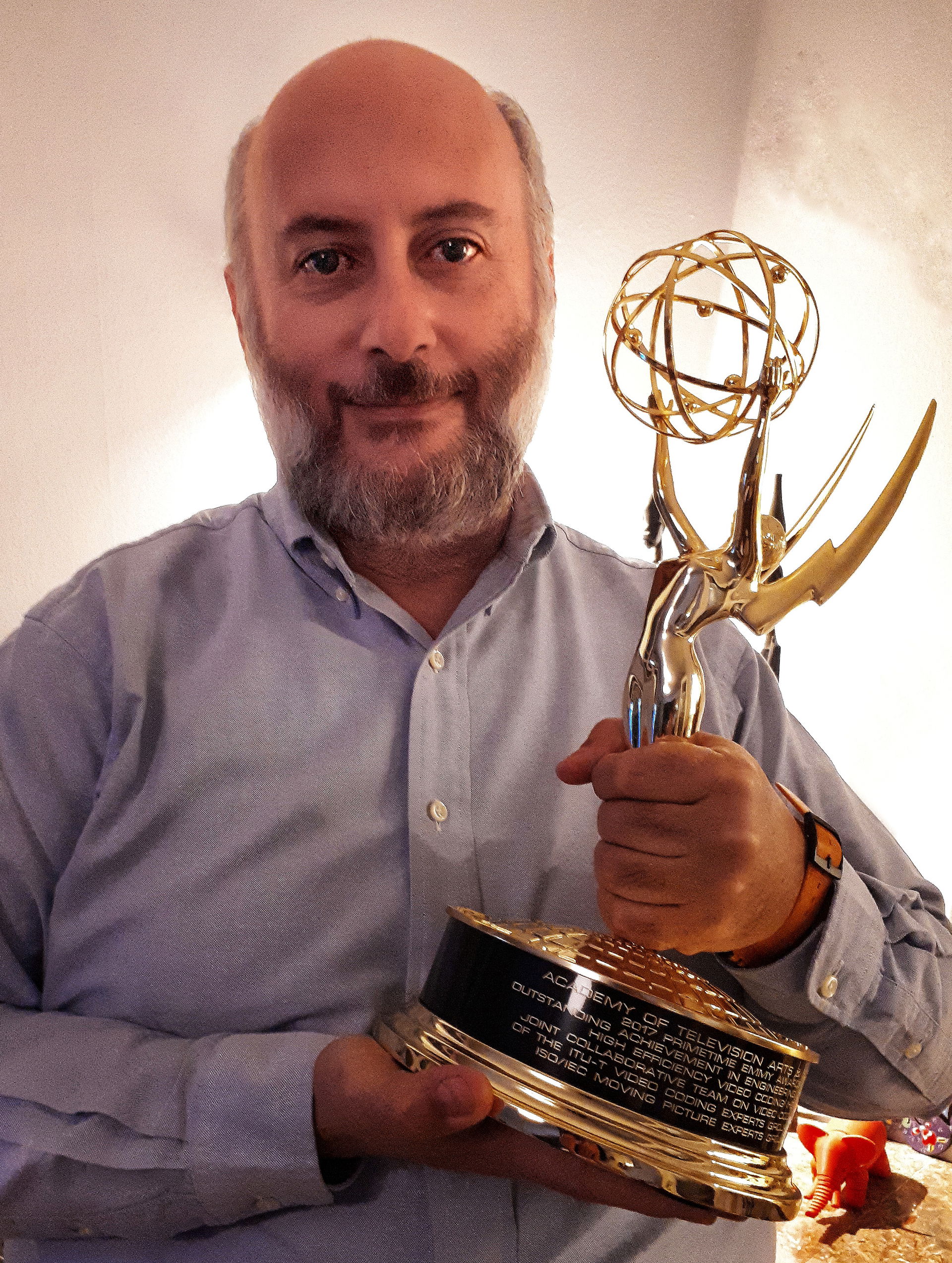 Simao Campos holding Emmy Award for JPEG