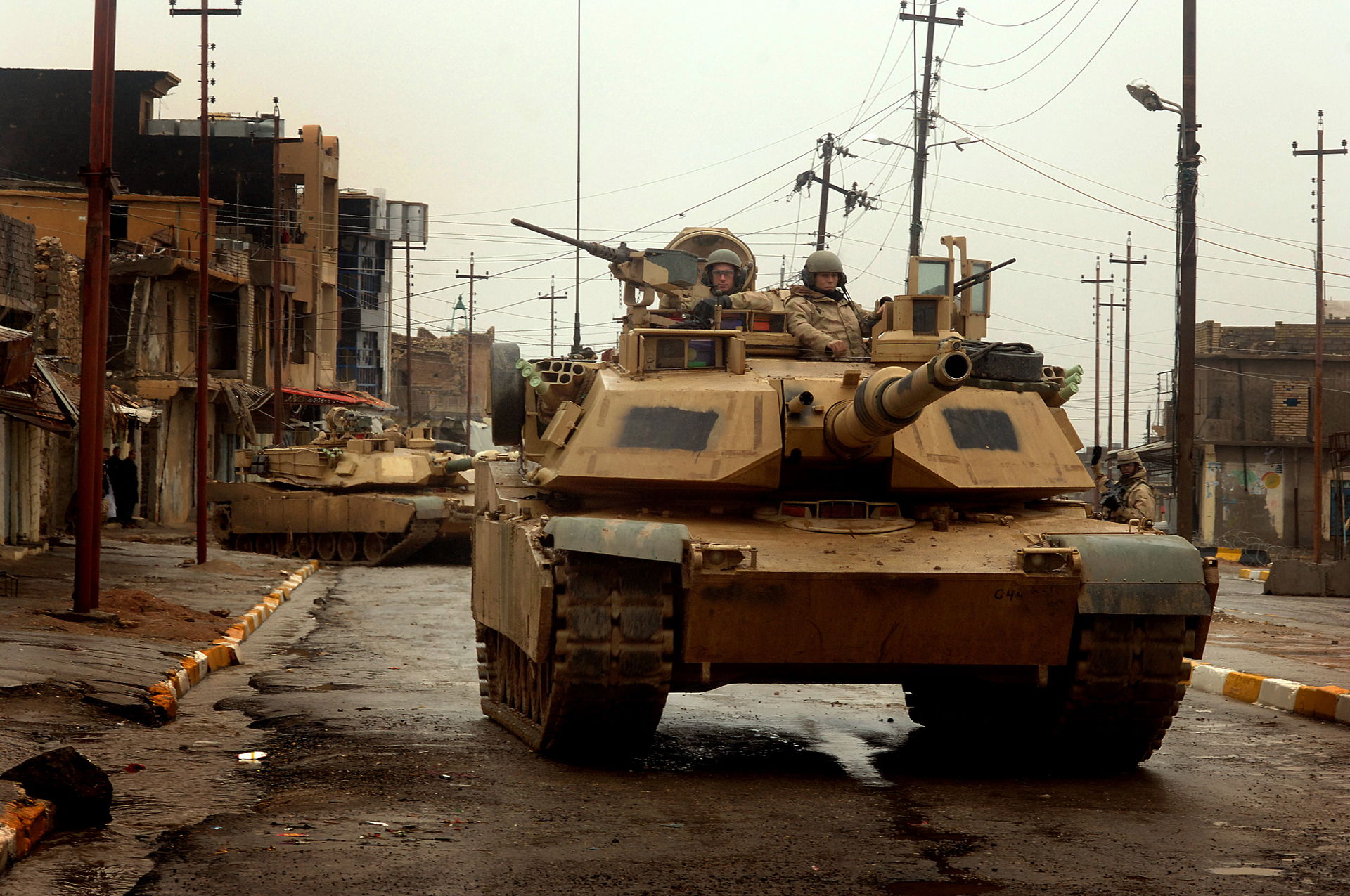 U.S. Army M1A2 Abrams tanks maneuver in the streets as they con…