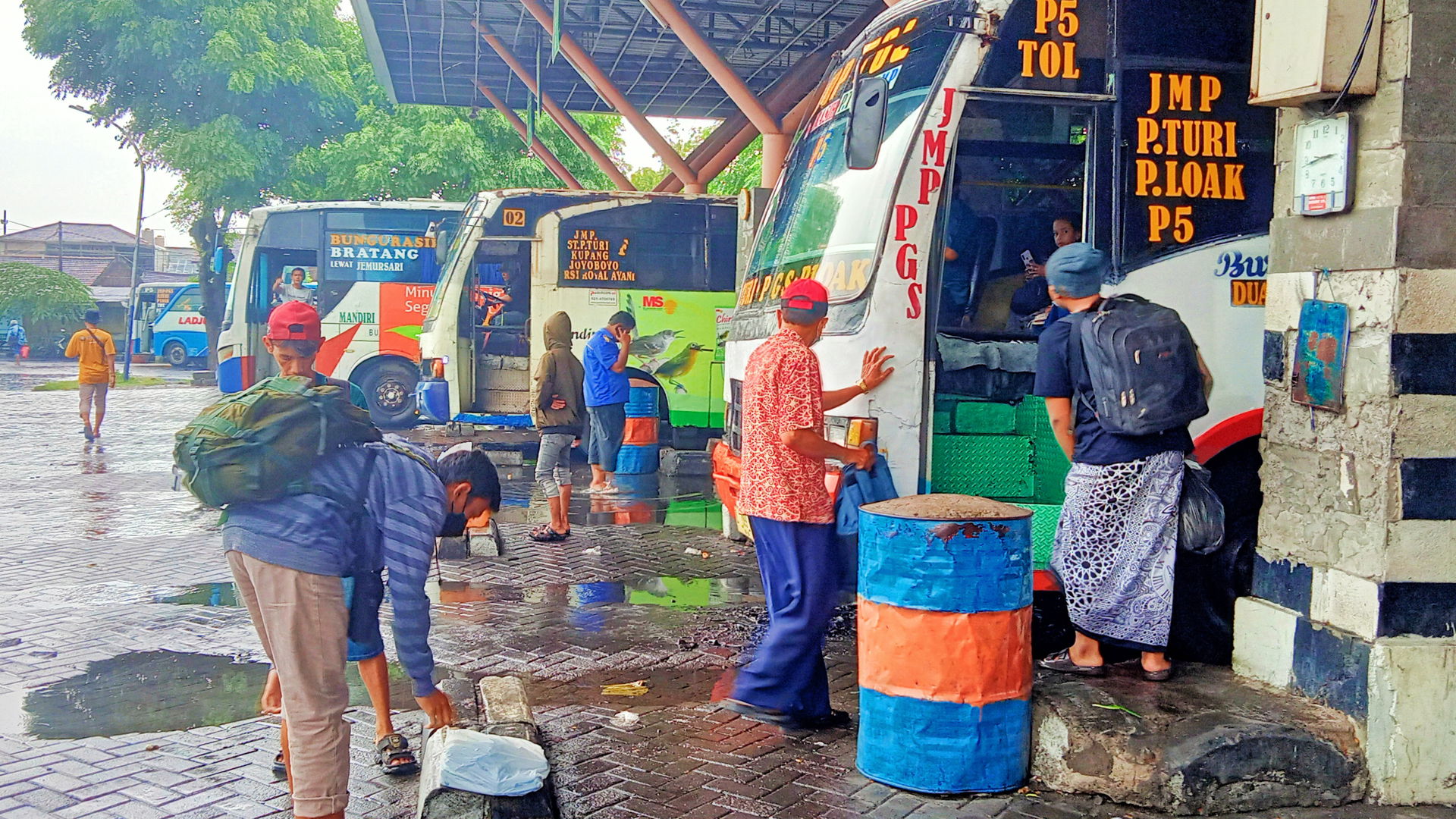Aktivitas calon penumpang dan kru bus kota menjelang sore hari …
