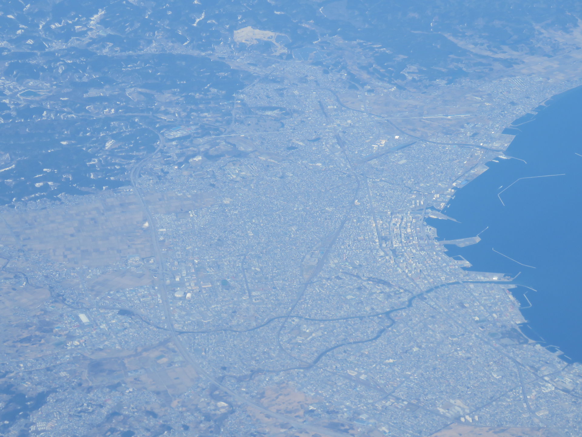 A view of Aomori, Japan, from the air. The view is from the eas…