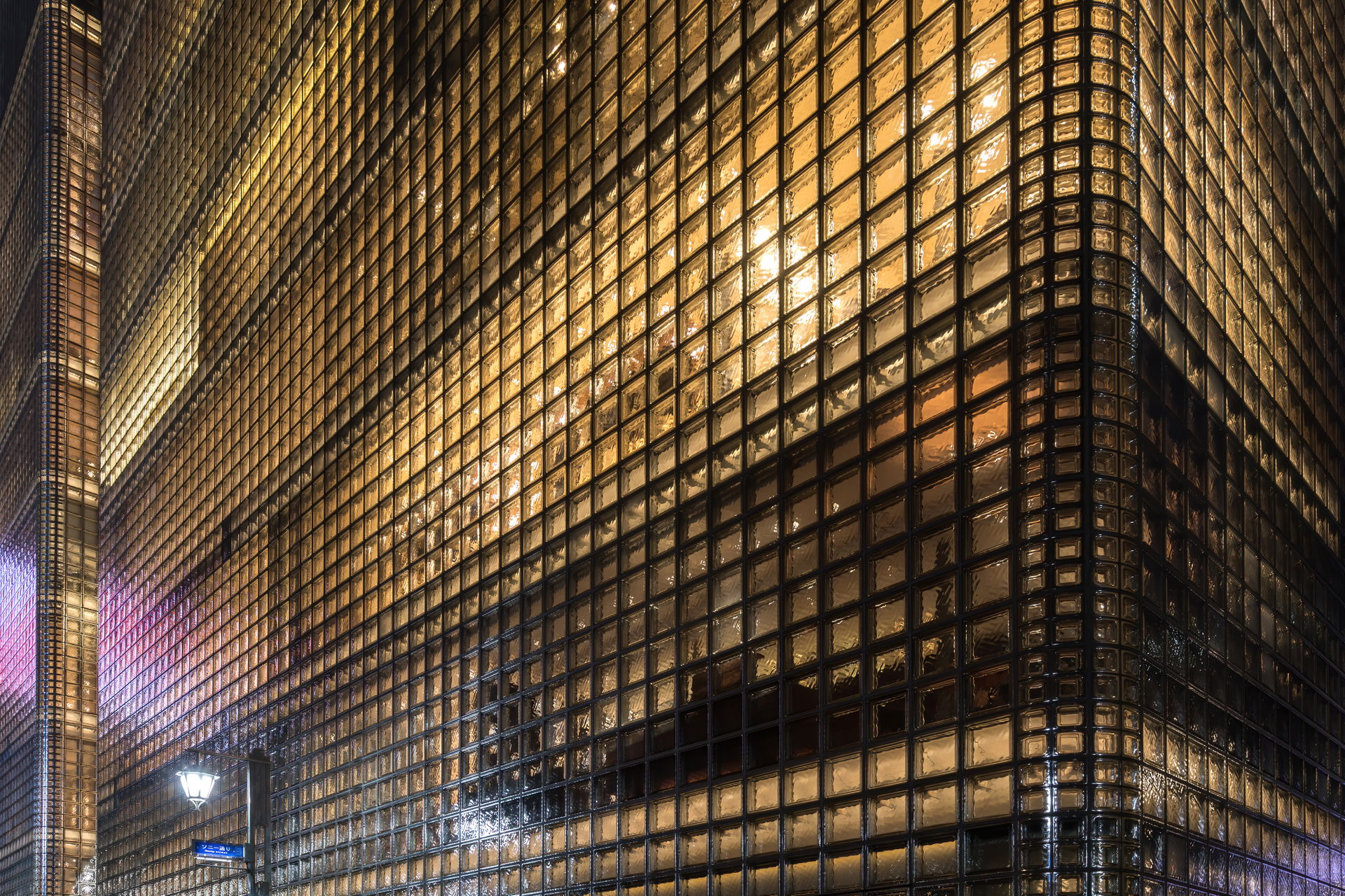 Exterior view of the illuminated facade of the building Maison …