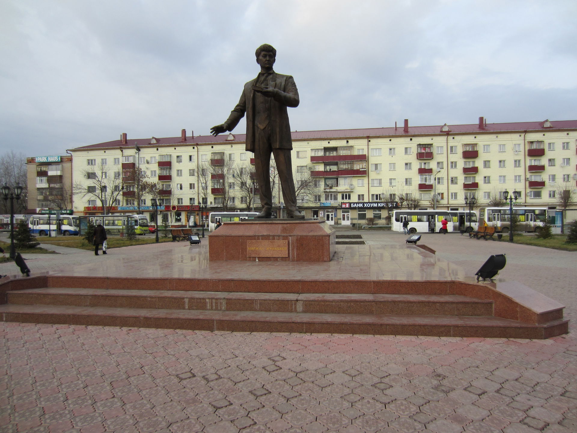 A statue of Mağjan Jumabayev in front of the train stration in …