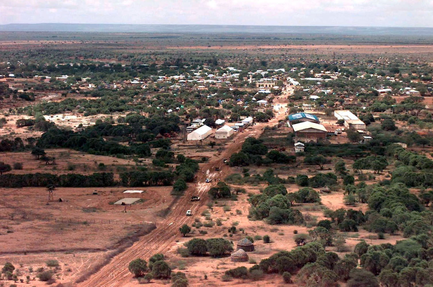 Aerial view of the Somali village of Bardera. Some vehicles are…