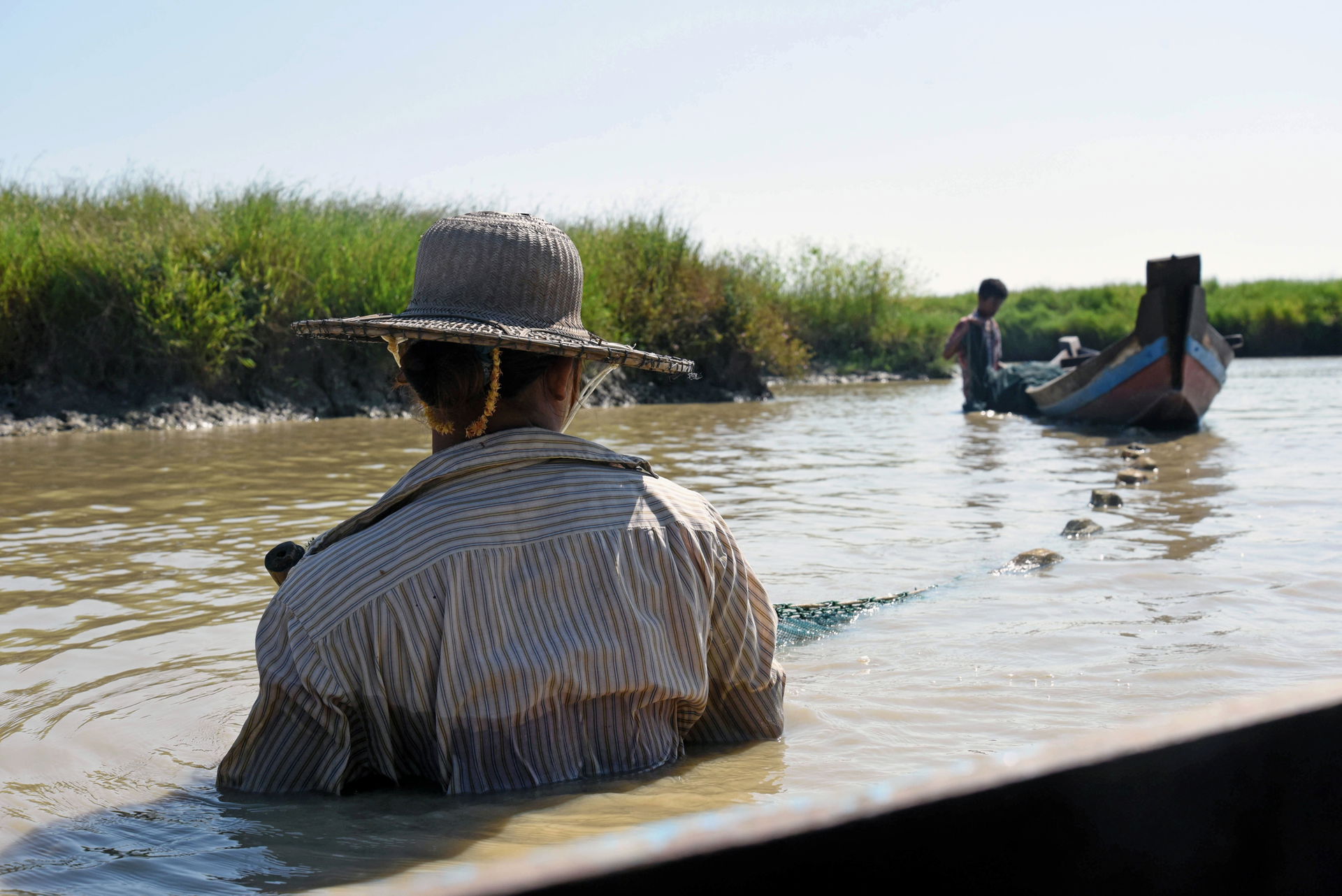 A man and a woman fishing close to their village in Kyonkadun, …