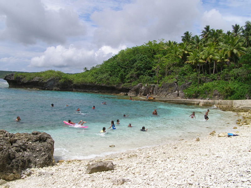 Swimmers enjoying the cool, pristine waters of Avatele Beach, N…