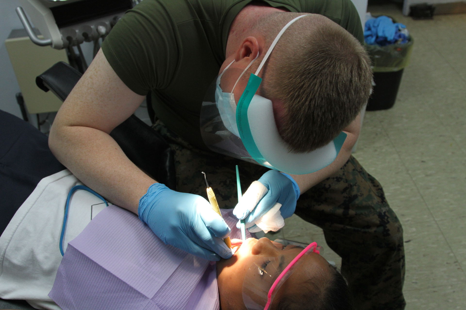 A child receives dental care from U.S. Navy Seaman Jeffrey M. K…