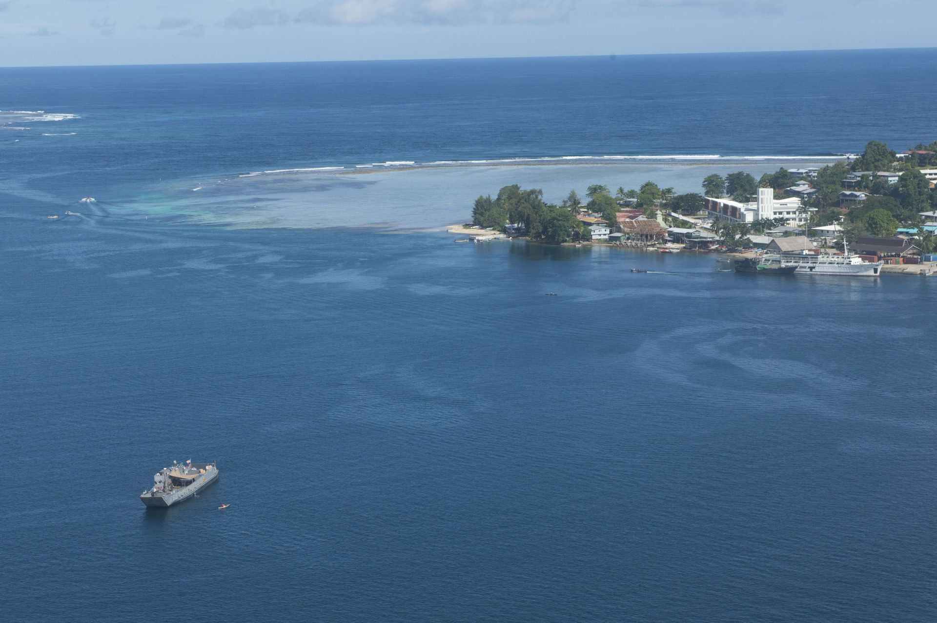 A landing craft utility sits off the coast of Gizo after transp…