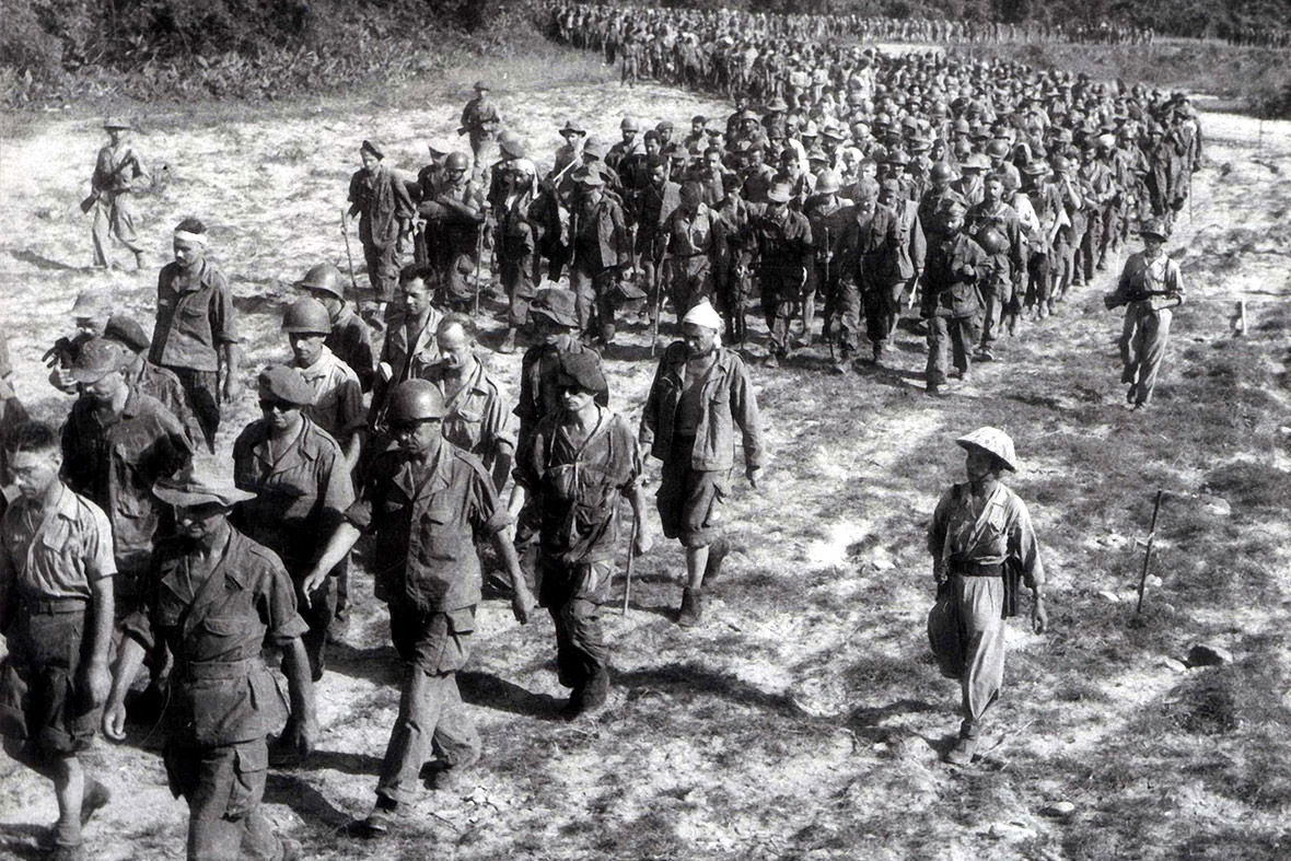 Captured French soldiers, escorted by Viet Minh troops, walk to…