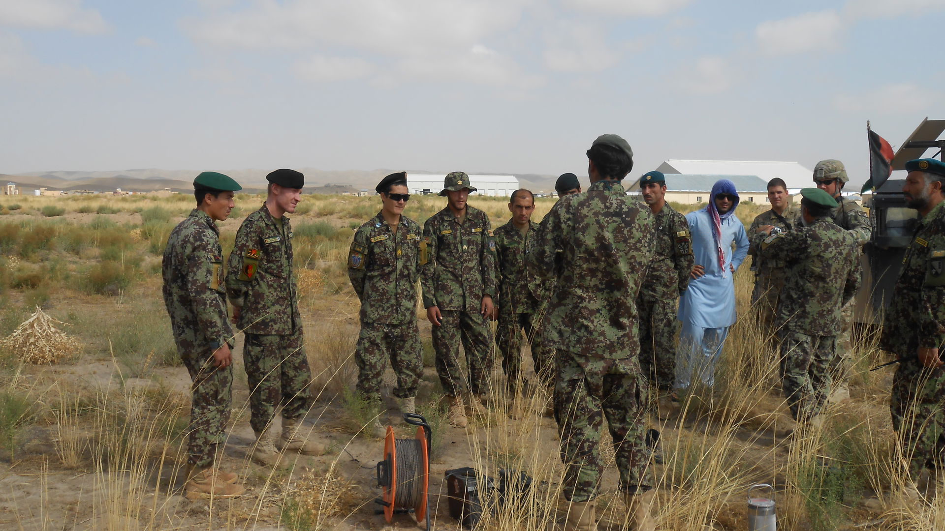 Afghan demolition students receive a safety brief from their in…