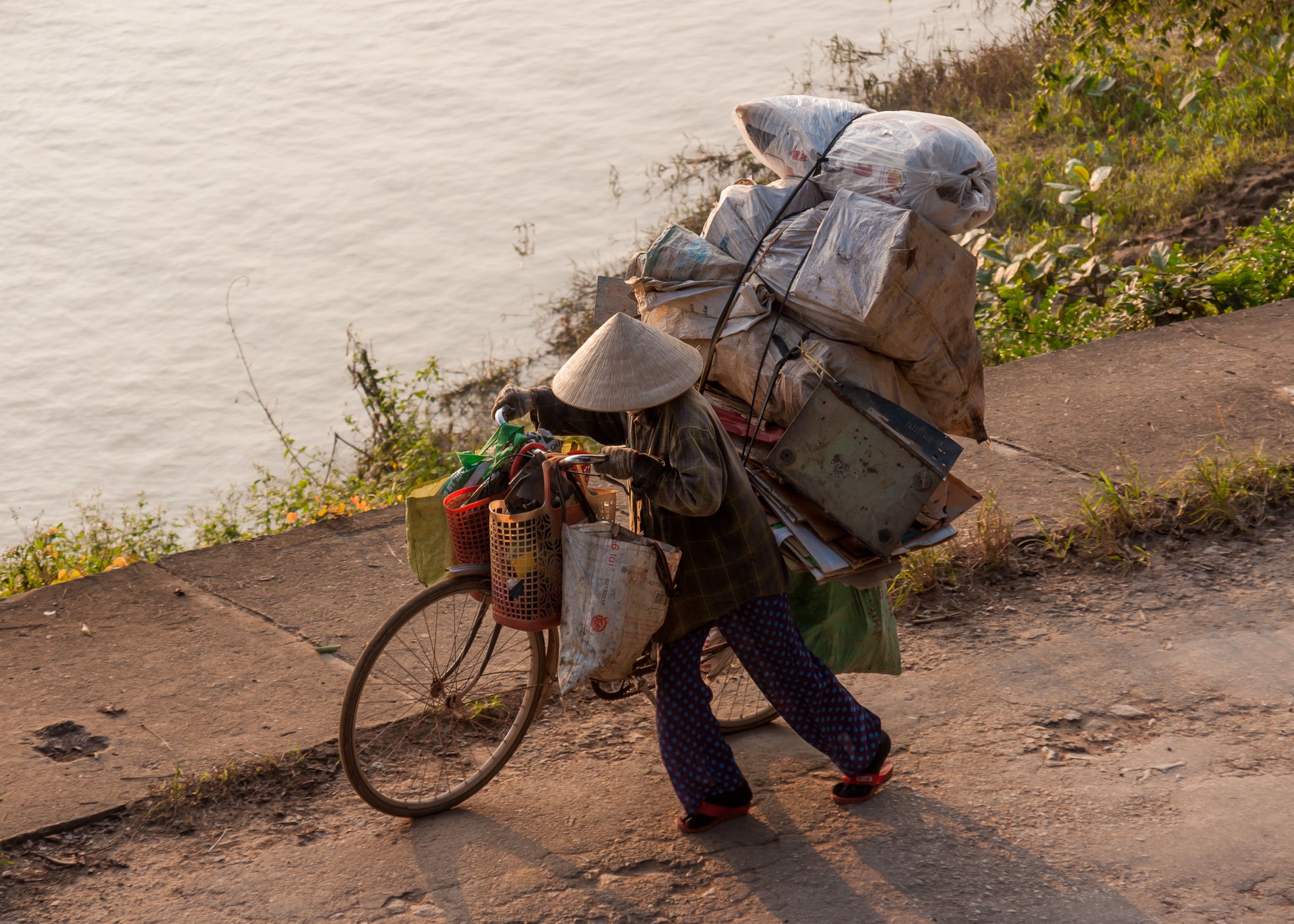 Hue, Vietnam: A lady using her bicycle as a means of transaport.