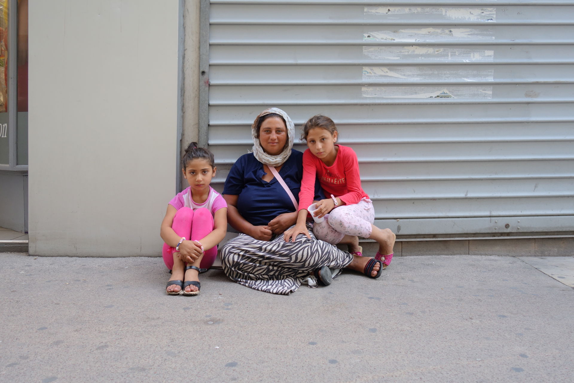 A poor family romani people in street in en:Saint-Étienne.
