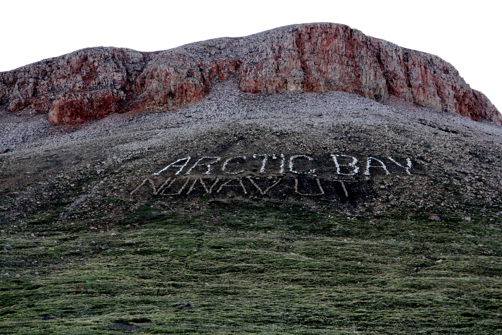 Laid out in rocks this welcome sign is located in the hills beh…