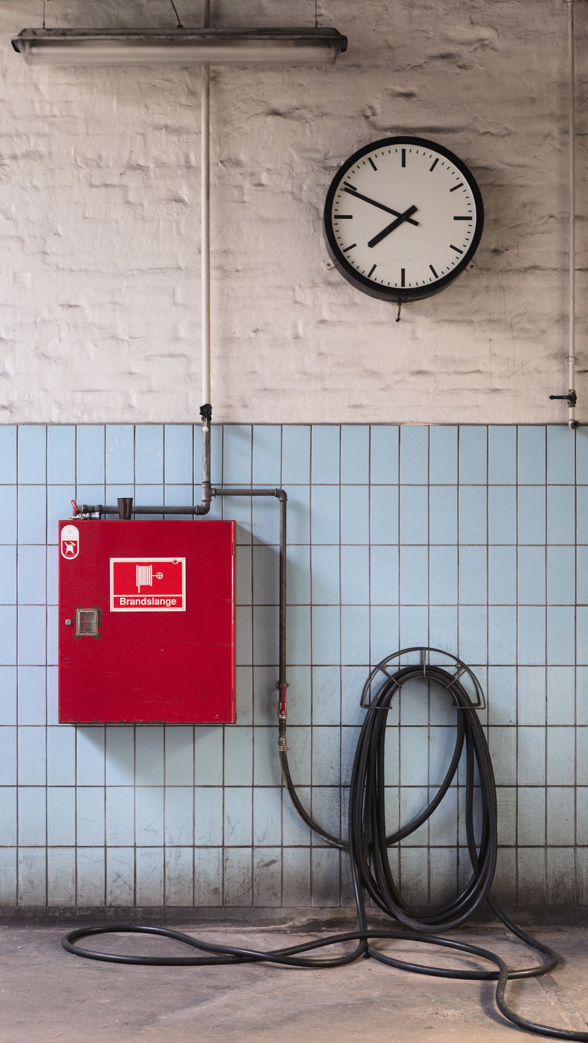 Fire cabinet, fire hose and clock in Denmark