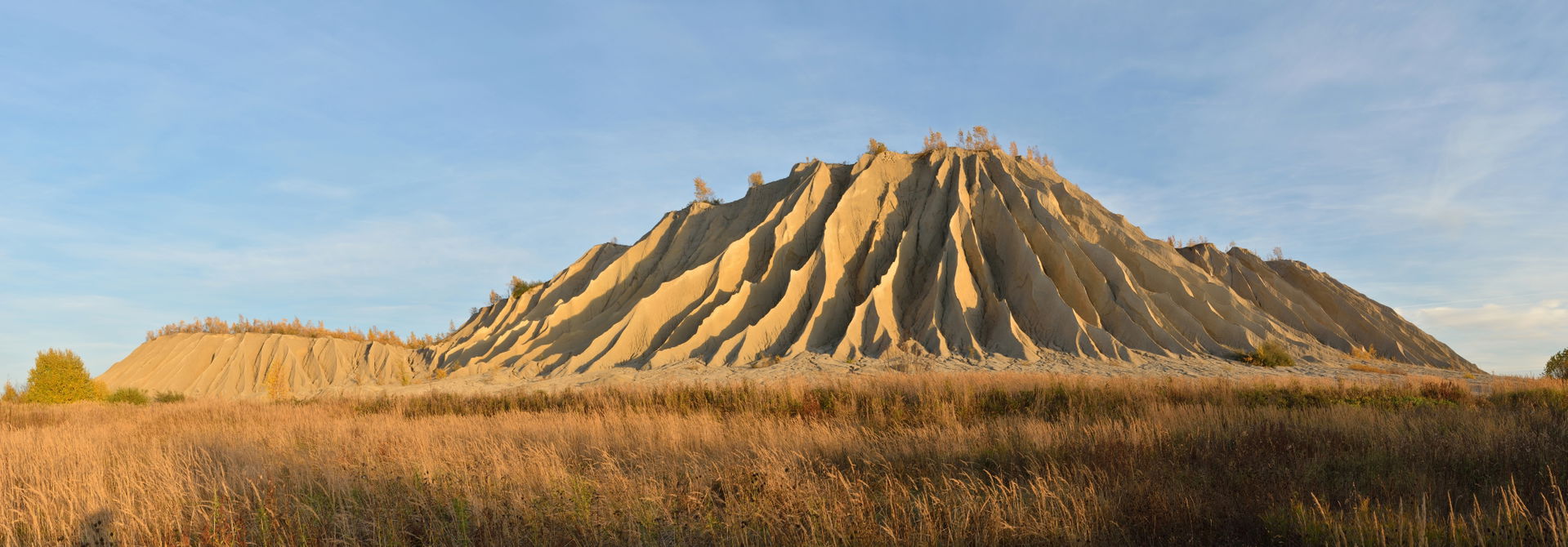 Spoil tip in Rummu, Estonia. Hillside is covered with rills and…