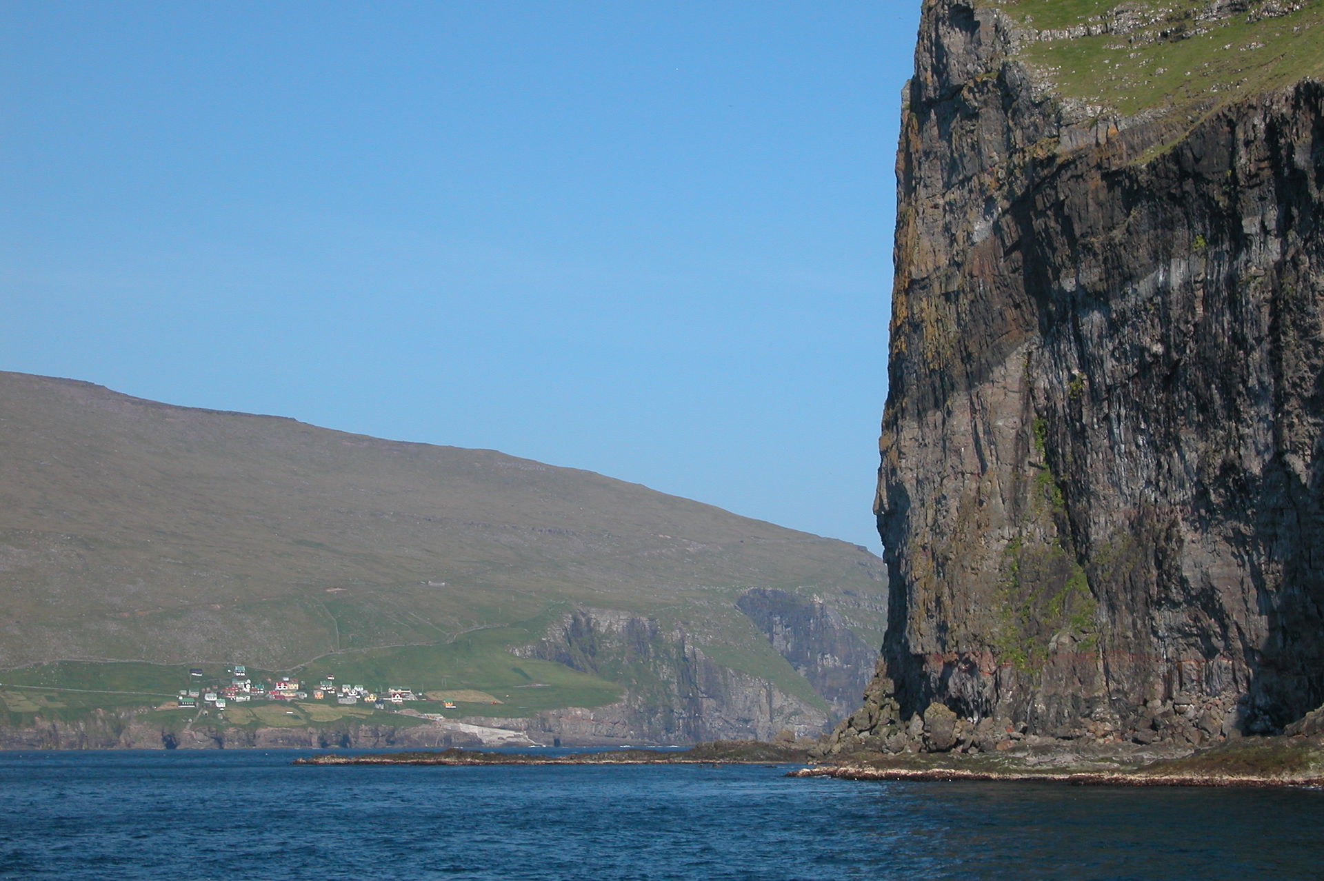 Kirkja on Fugloy, Faroe Islands. (a cliff of Svínoy in the fore…
